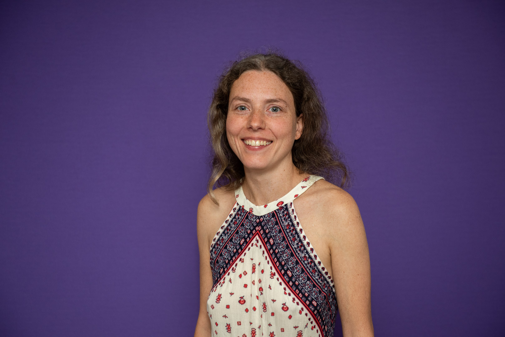 Tatiana Aitken tantric massage therapist wearing a blue and white dress