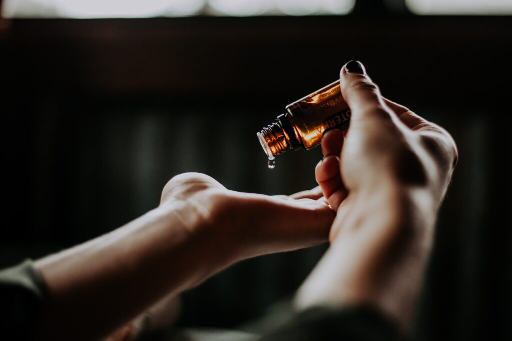 Massage oil dripping into a person's hand